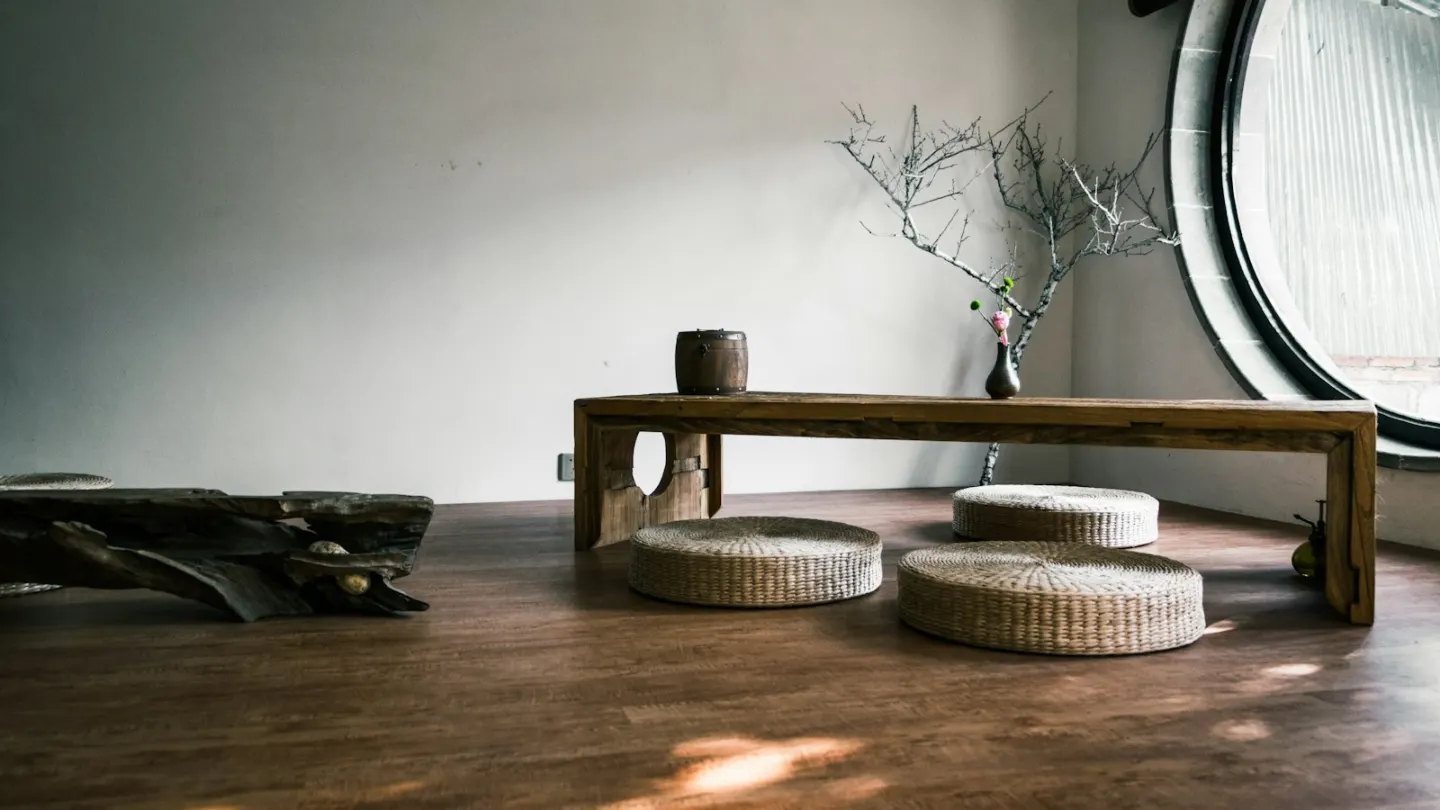 brown wooden bench near window