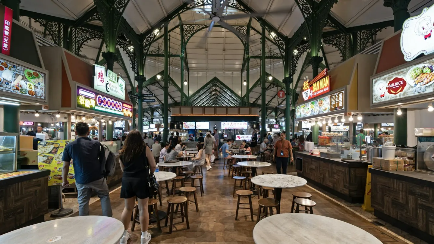 A group of people walking through a food court