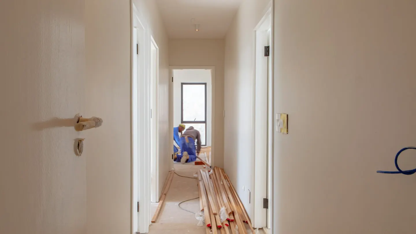 a couple of men working on a house