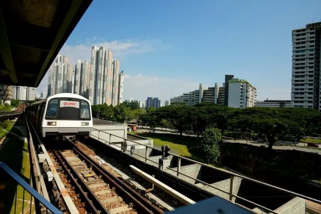 white train on rail during daytime