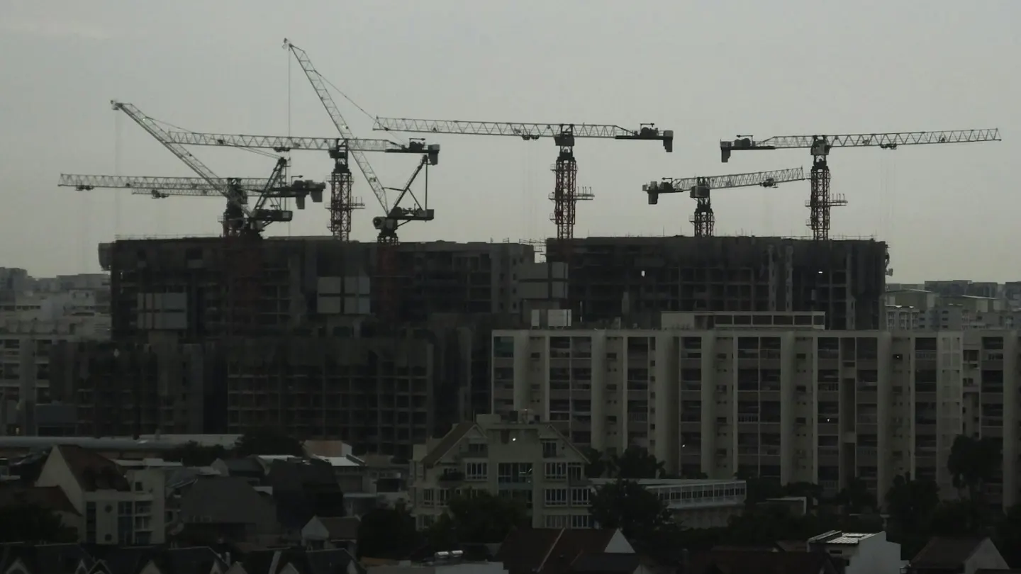 a group of cranes that are on top of a building