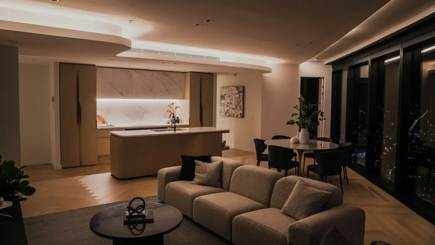 a living room filled with furniture and a kitchen