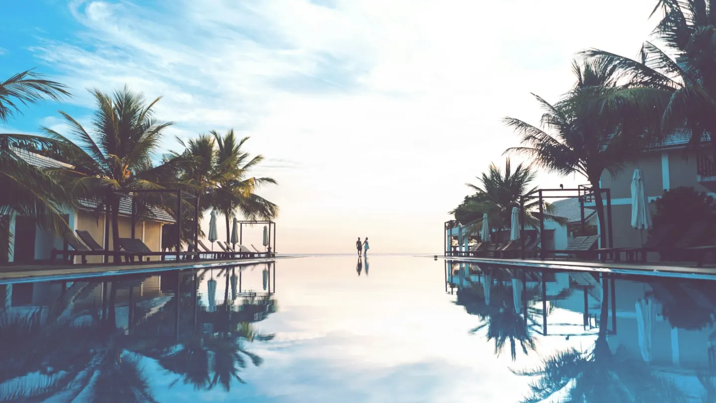 two person standing beside swimming pool