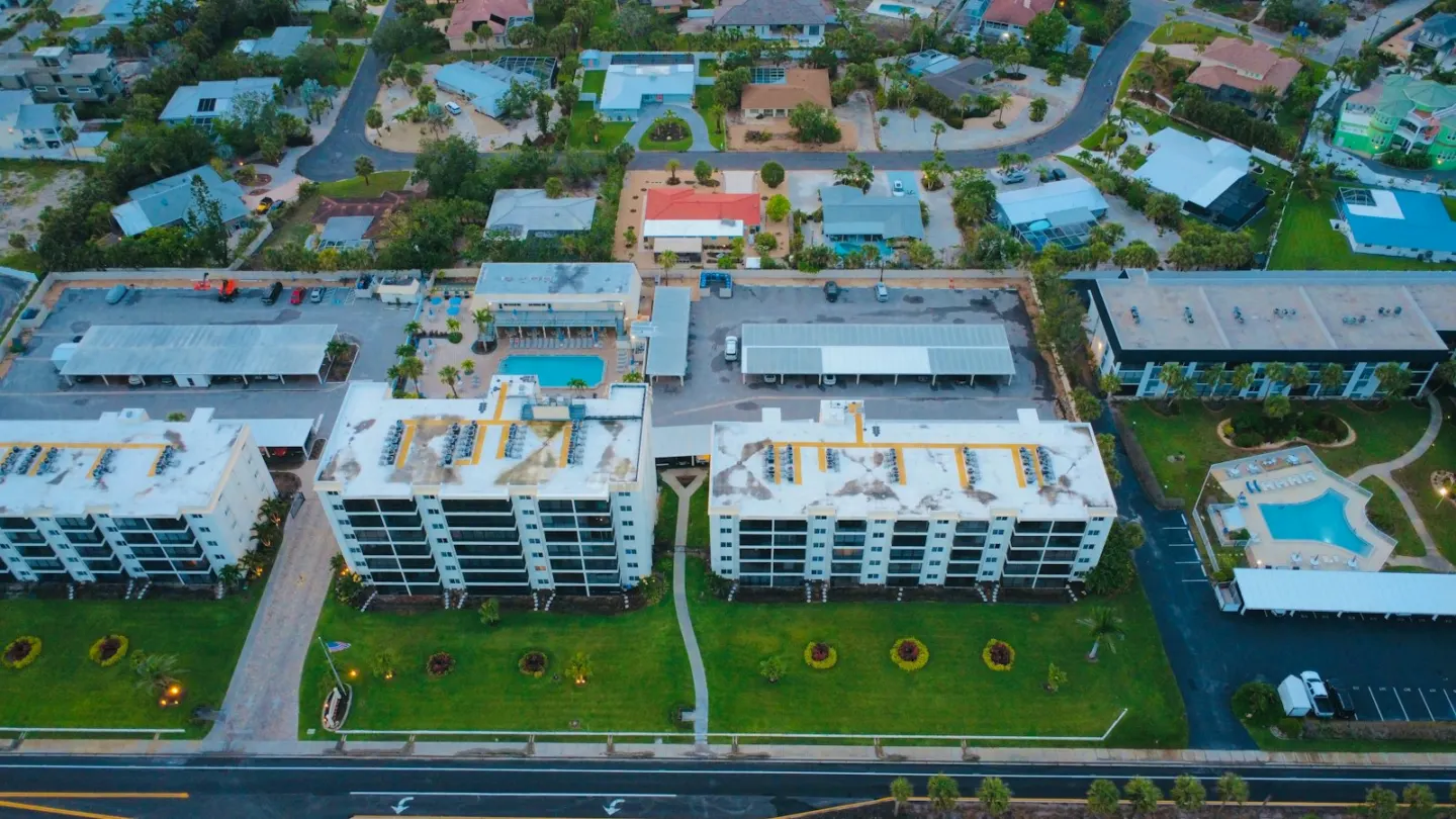 Aerial view of buildings, cars, and green space