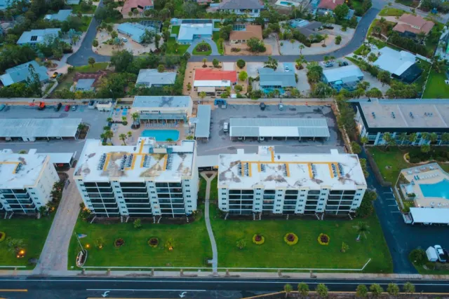 Aerial view of buildings, cars, and green space