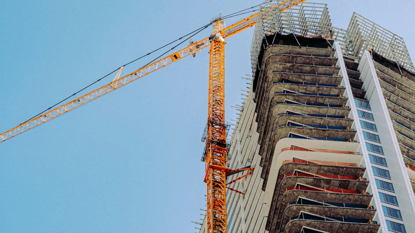 orange crane on top of building